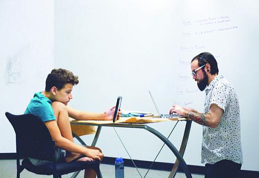 Dominic Maciel studies with his social studies teacher Michael Ponce at Halstrom Academy in Cupertino, Calif. Photo by Magali Ga