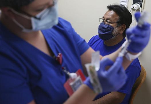  Albert Gutierrez waits for his COVID-19 vaccine at Texas Vista Medical Center in March 2021. 