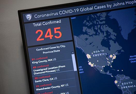Outbreak map dashboard being used by officials to track the virus. (Photo by Samuel Corum/Getty Images)