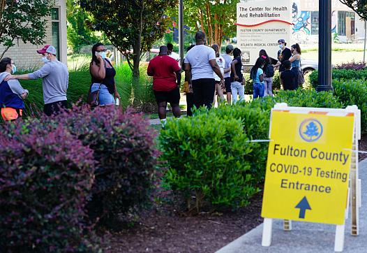 People stand in line to get tested for COVID-19 at a free walk-up testing site on July 11, 2020 in Atlanta, Georgia