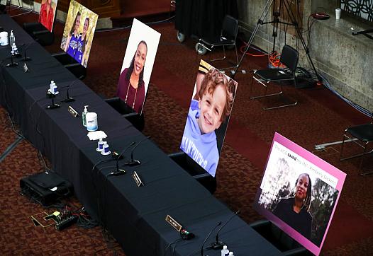 Pictures of people helped by the Affordable Care Act occupy the seats of Democratic senators boycotting a Senate Judiciary Commi