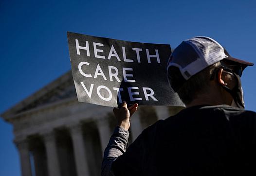 A supporter this of the Affordable Care Act in front of the Supreme Court, which heard arguments in the case against the ACA on