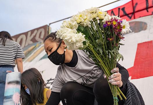 A group paints a mural denouncing anti-Asian hate in Atlanta, Georgia, after a shooting there left eight dead, including six wo
