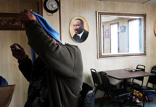 A man takes off his scarf at a restaurant in Biloxi, Mississippi. 