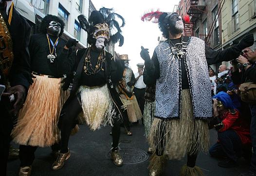 Members of the Zulu Social Aid and Pleasure Club dance in the French Quarter during Mardi Gras festivities in New Orleans