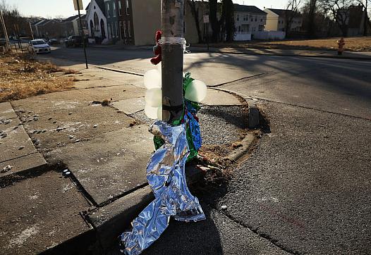 Deflated balloons hang from a lamppost where a person was killed in Baltimore, Maryland. Neighborhoods that lack quality schools