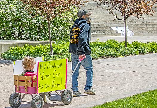 A man pulls a wagon at an “Open Ohio” protest rally in front of the statehouse this spring.