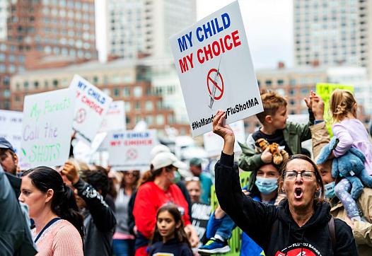 Demonstrators protest a flu vaccine order for children outside the John Joseph Moakley United States Federal Courthouse in Bosto