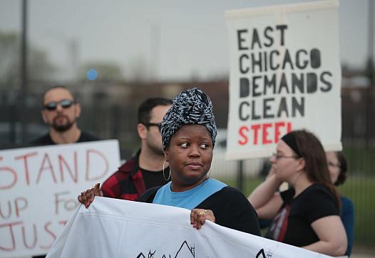 Environmental activists protest outside a Chicago elementary school closed in 2016 after high levels of lead and arsenic were fo