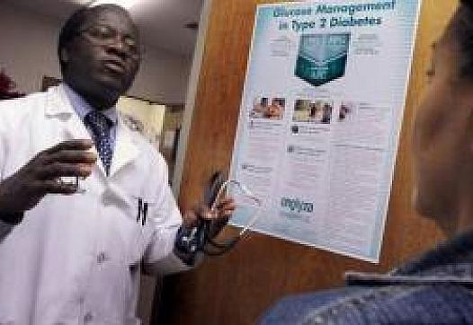 Dr. Kwabena Adubofour talks to Yolanda Reyes, 54, about diabetes and its health risks at the East Main Clinic & Stockton Diabete