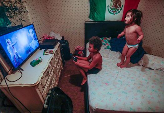 Romeo, 8, and his sister Victoria, 3, play in their mobile home. The family was among those profiled in the reporter’s series on