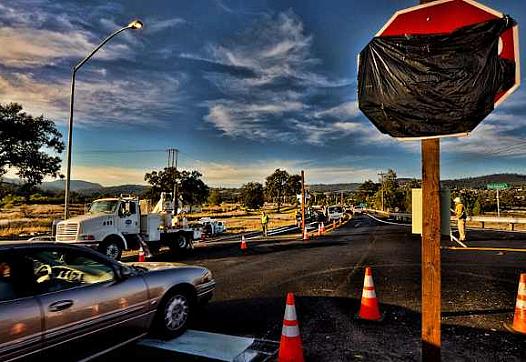 Caltrans workers installed three-way stop signs at the intersection of Hartmann Road and Highway 29 near Middletown, Calif., on 