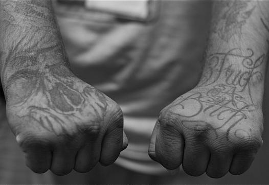 Tattoos — symbols of the struggle of his earlier years — warn you against crossing a former gang member. (Photo by Sahra Sulaiman/LA Streetsblog)