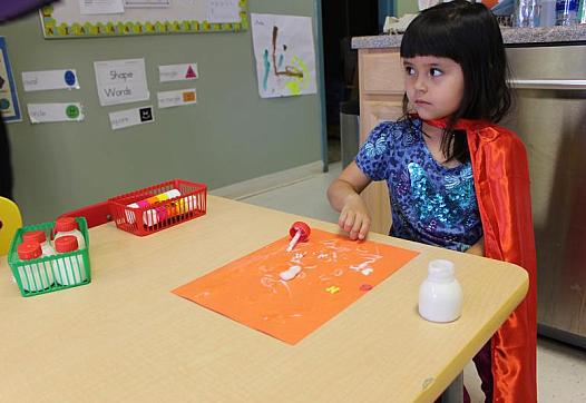 Alexis plays arts and crafts at Conjunto preschool in Española.