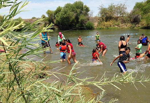 On a 105 degree day, kids play in the San Joaquin River as part of River Camp. Ezra David Romero Valley Public Radio