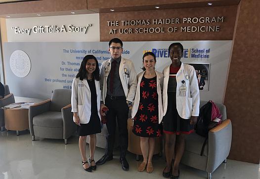 UCR medical students Jericha Viduya, Antonio Garcia, Monica Gutierrez, and Kleshie Baisie pose for a picture in their white coat