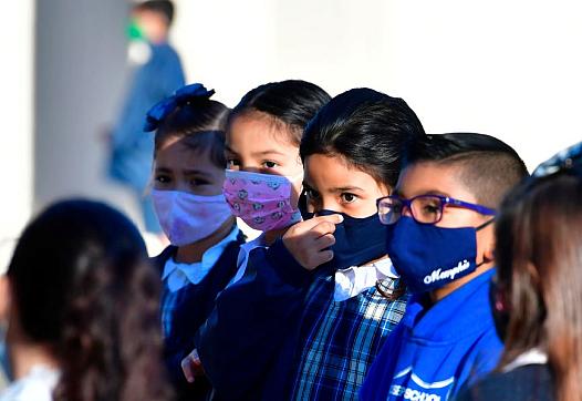 A student adjusts her facemask at St. Joseph Catholic School in La Puente, California in November 2020