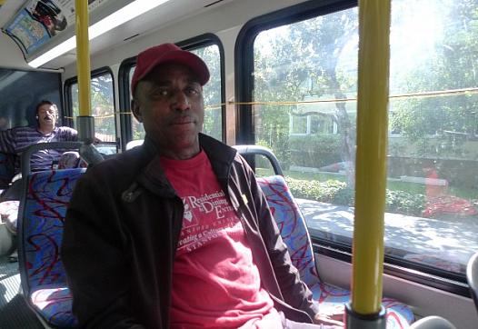 Leaburn Alexander works two jobs and does not have health insurance. Here, he is on the start of his 3-hour commute home from the job he works as an overnight hotel janitor. (Lisa Morehouse/KQED)