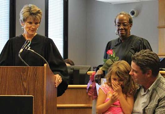 Judges Julia Garratt (far left) and Patricia Clark (center) at a family treatment court graduation in Seattle. 