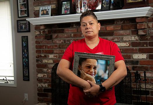  Daisy Duarte holds a photo of her mother, Sonia Calderon, who died earlier this year from Alzheimer's disease. 