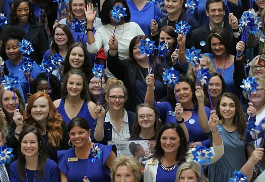Rally-goers gather at the Arkansas Capitol on April 18, 2019 for an event designed to bring awareness to child abuse.