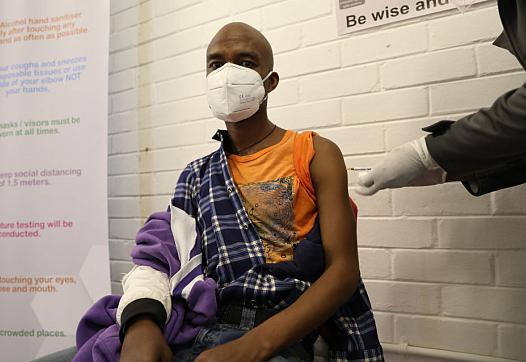 A volunteer participating in Oxford’s COVID-19 vaccine trial receives a shot in South Africa on June 24.