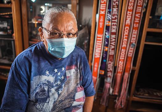 Laverne Blackhorse sits in front of pageant ribbons won by her daughter Valentina, who was one of the first COVID-19 deaths on N