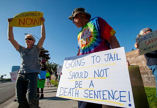 Andy Lewandowski, center, of Anaheim takes part in a rally outside the Theo Lacy Facility in Orange on Saturday, July 20, 2019 t