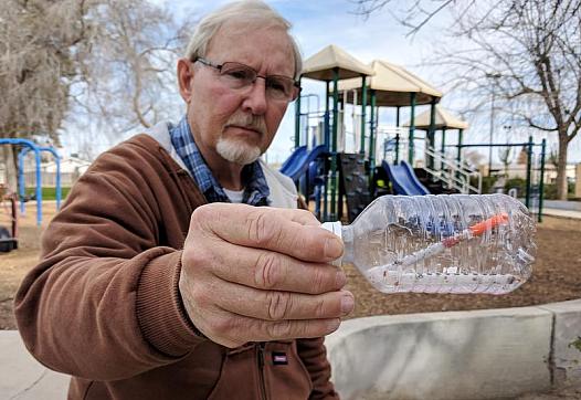 Oildale Community Action Team director Dave Kadel stands with a hypodermic needle he found.