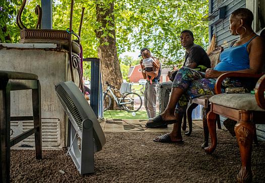 Yvette Johnson and her family outside of her home during a heatwave in July 2022 in Houston, Texas. "It’s too much heat inside m