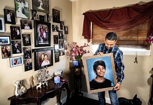 Felipe Salcedo holds a framed picture of his late nephew, Diego Stolz, at his Moreno Valley home Wednesday, March 23, 2022. The 