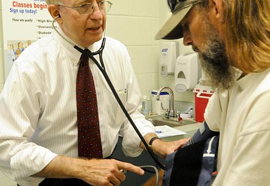 Dr. Michael Lewis, secretary of the state Department of Health and Human Resources, volunteers at the West Virginia Health Right