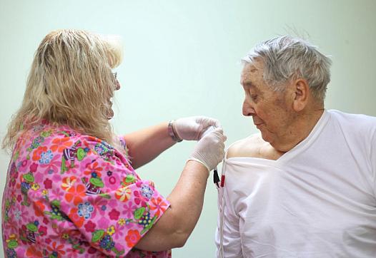 Ray Ingram, 86, gets help with shock therapy from clinic employee Kelly Dority at Helton Rural Health Clinic in Coalgate, Okla. 