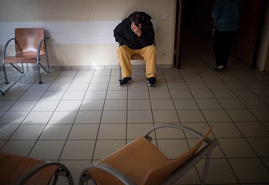 Man seated in clinic waiting room