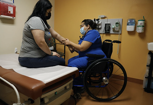 Dr. Marie Flores examines patient Karla Olguin, 35, at the AltaMed clinic in Pico Rivera.