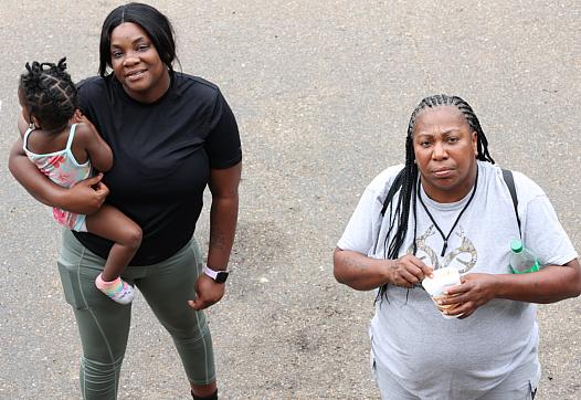 Jasmine Sandifer, left, whose mother is a resident at Sunset Village, and Doris Williams, right, wait outside their motel rooms