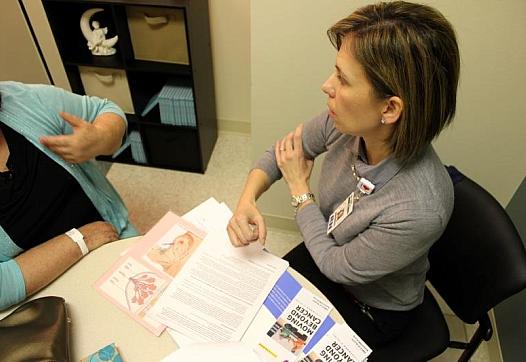 Seton Survivorship Nurse Navigator Veronica Serrano, right, helps a purposely unidentified former cancer patient on Nov. 19, 2014. Veronica Zaragovia/KUT
