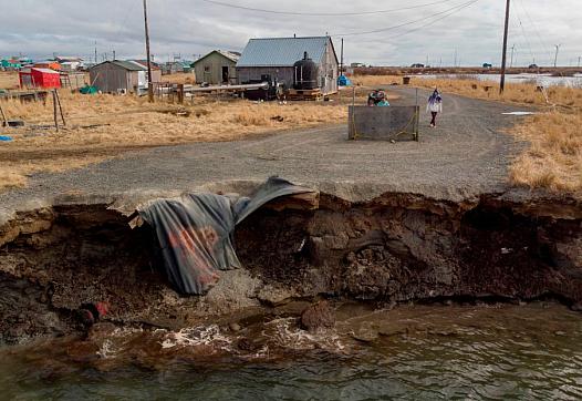 Erosion caused by melting permafrost tundra and the disappearance of sea ice threatens houses from the Yupik Eskimo village