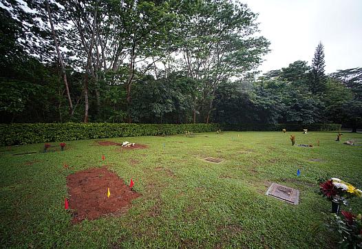 Fresh earth covers the grave of Neita Bolkeim at Hawaiian Memorial Park in Kaneohe.