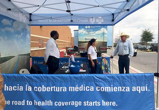 Insurance agents working with Blue Cross Blue Shield of Texas answered questions outside of a Target in San Antonio from potential customers on Dec. 12, 2014. Veronica Zaragovia/KUT