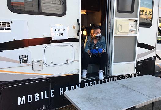 Michaella Jones hands out sterile supplies from the HEPPAC mobile outreach vehicle in April 2020.