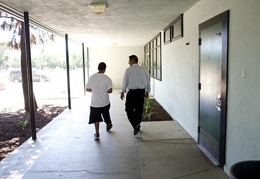 Teacher and student walk down hallway