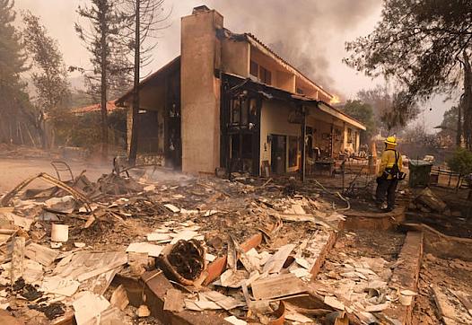 A firefighter keeps watch during the Woolsey Fire in Malibu, California on Nov. 9, 2018.