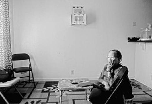 Mai Yang, a Hmong refugee who’s father was killed fighting for the CIA’s “Secret Army,” sits remembering those days in her home