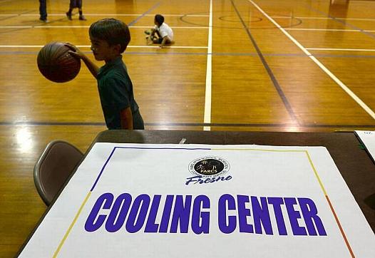 Kids play basketball at Ted C. Wills Center, on 770 N San Pablo Ave, Fresno which is one the four cooling centers in the city of