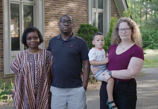 Paul Gakpo (second from the left) lives in Kentucky with his wife, Michelle (far right) and son, Louis. The family poses for a p