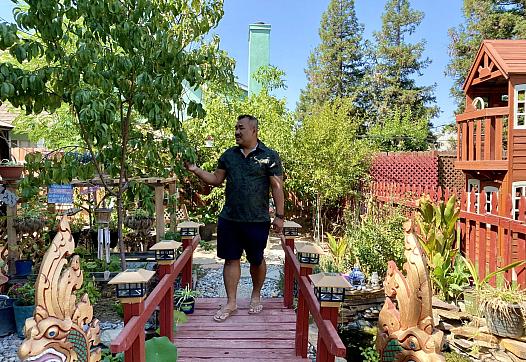 Danny Kim walking in his backyard garden on Sept. 15 in Fresno, Calif.