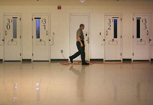 A Sonoma County sheriff corrections officer makes his rounds in the mental health wing at the Sonoma County Main Adult Detention