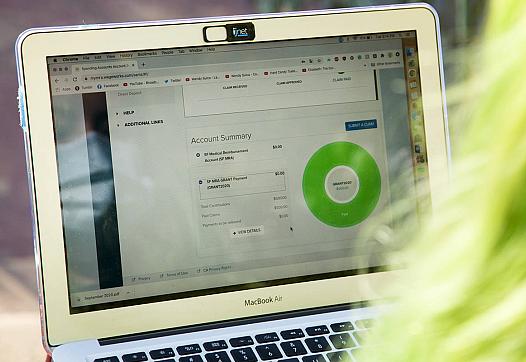 Nicole Canedo looks at her city-issued Medical Reimbursement Account page on her computer outside her Berkeley apartment.