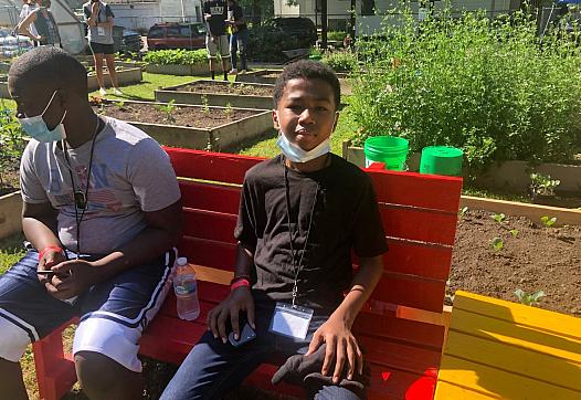 Izaiah Cole, 14, takes a break after cleaning up several blocks near the We Got This urban garden with columnist James E. Causey